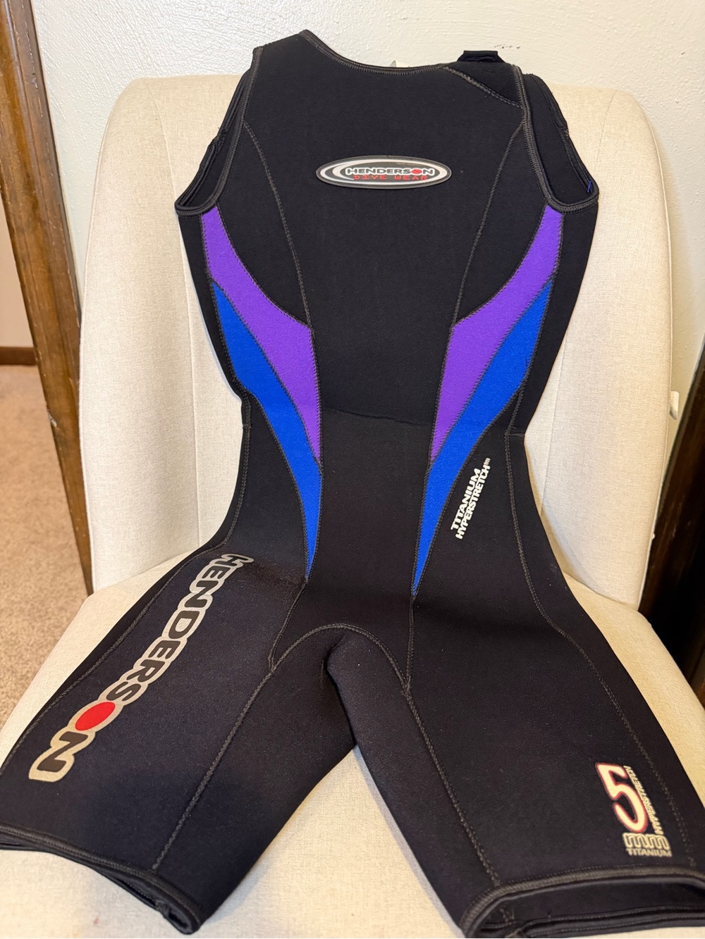 Henderson womenโs One-Piece Wetsuit in Black with Purple & Blue Accents